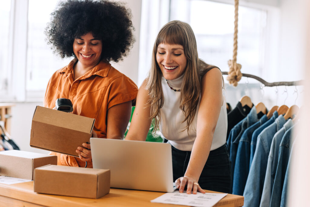 Women smiling while scanning packages.