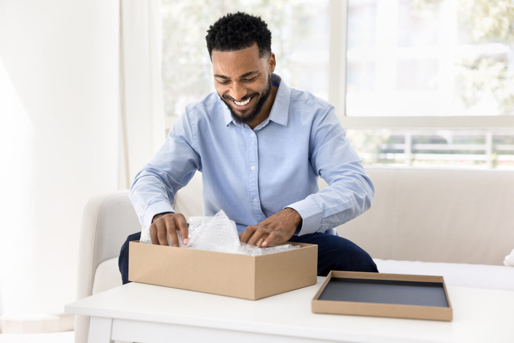 Happy man smiling at box.